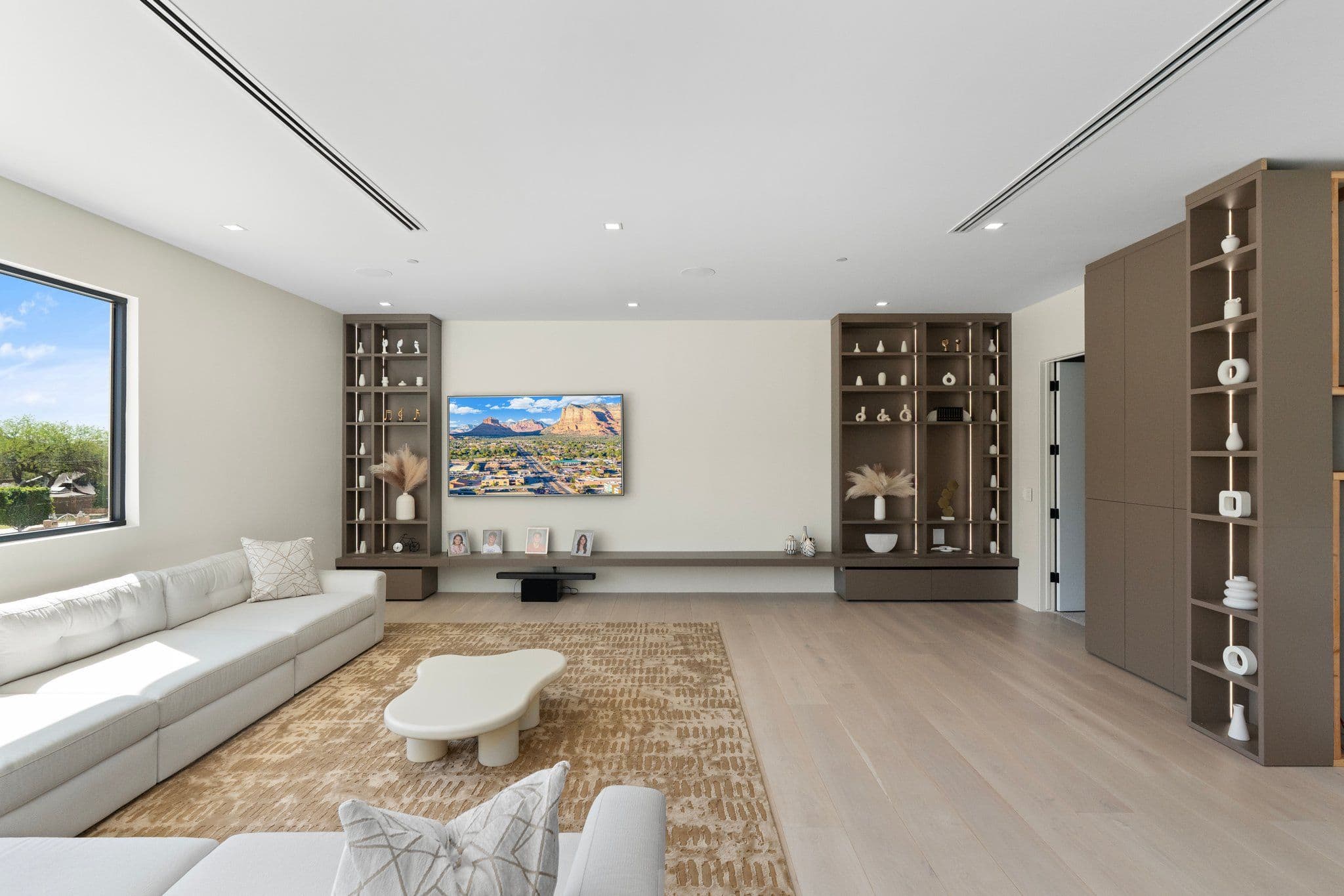 Stylish gaming room with ambient lighting and modern decor, part of the Modern Desert Oasis collection for a luxurious entertainment space.