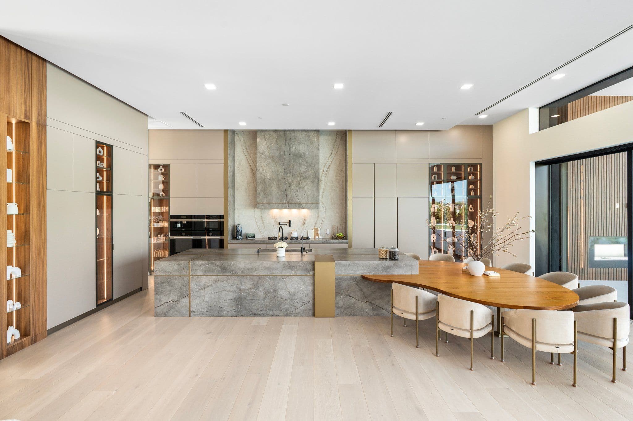 Modern kitchen with large island and open layout, featured in the Modern Desert Oasis collection for a seamless cooking experience.