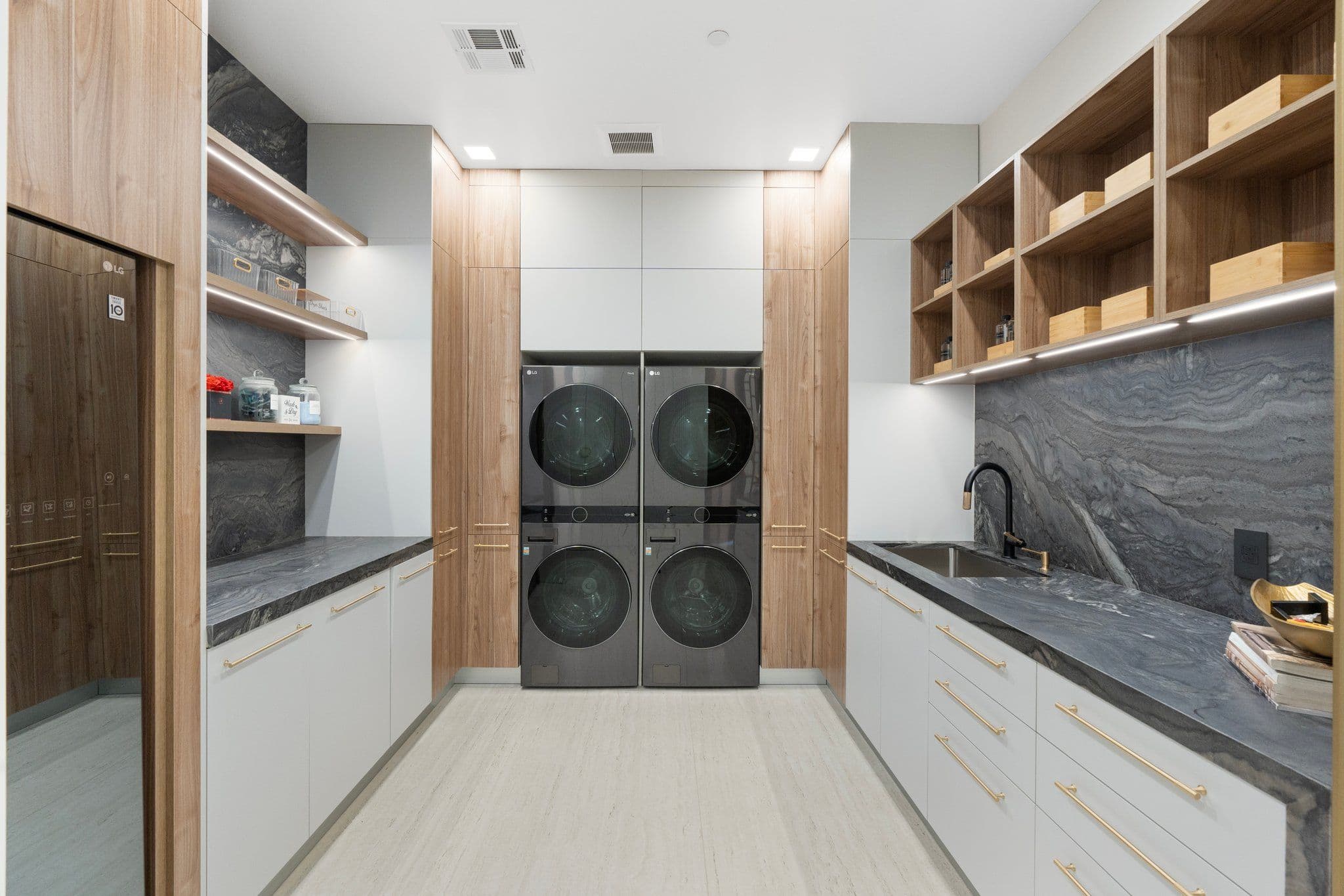 Modern laundry room with sleek cabinetry and efficient design, included in the Modern Desert Oasis collection for practical home solutions.