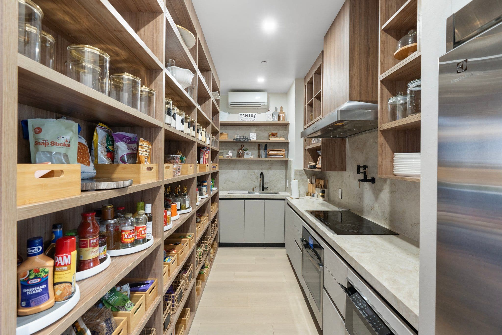 Spacious pantry with organized shelving and modern lighting, featured in the Modern Desert Oasis collection for efficient home storage solutions.